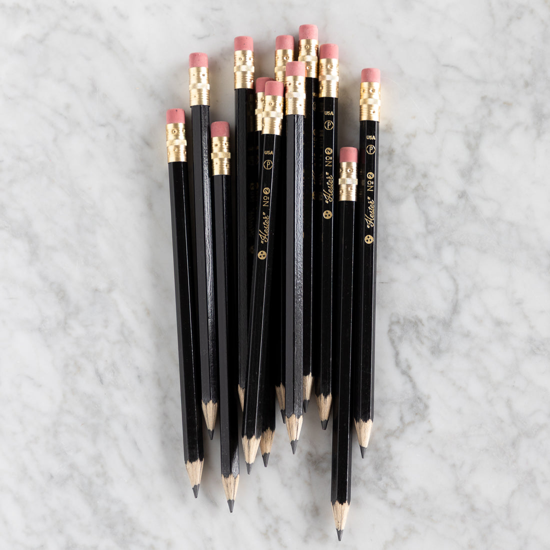 Group of Black Jumbo Hex Pencils on a marble background. 