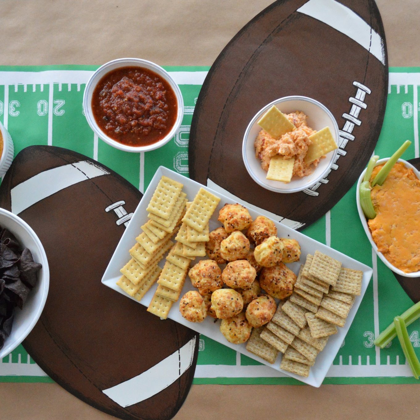 A football themed party with Hester &amp; Cook Die-cut Football Placemats and other snacks.