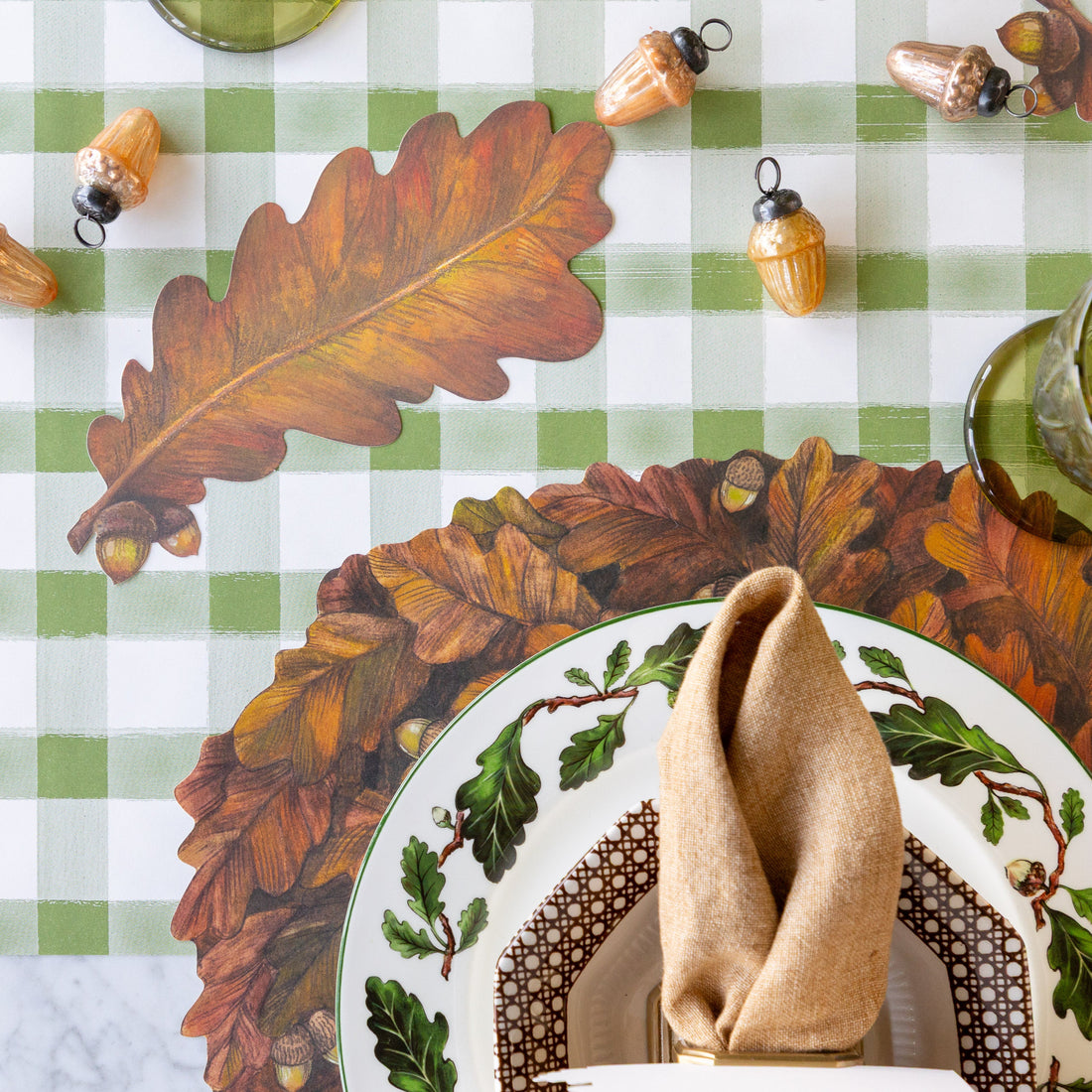 Table setting with the Die-cut Autumn Wreath Placemat, Autumn Leaf Table Accent and Glass Acorn Ornaments on the Moss Painted Check Runner.