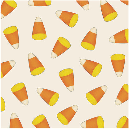 A square, cream cocktail napkin scattered with yellow, orange and white candy corn.