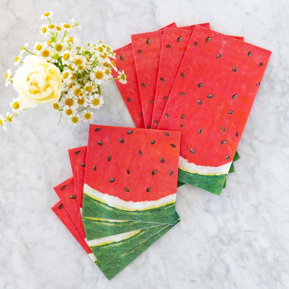Watermelon Cocktail and Guest Napkins on a marble table with flowers.