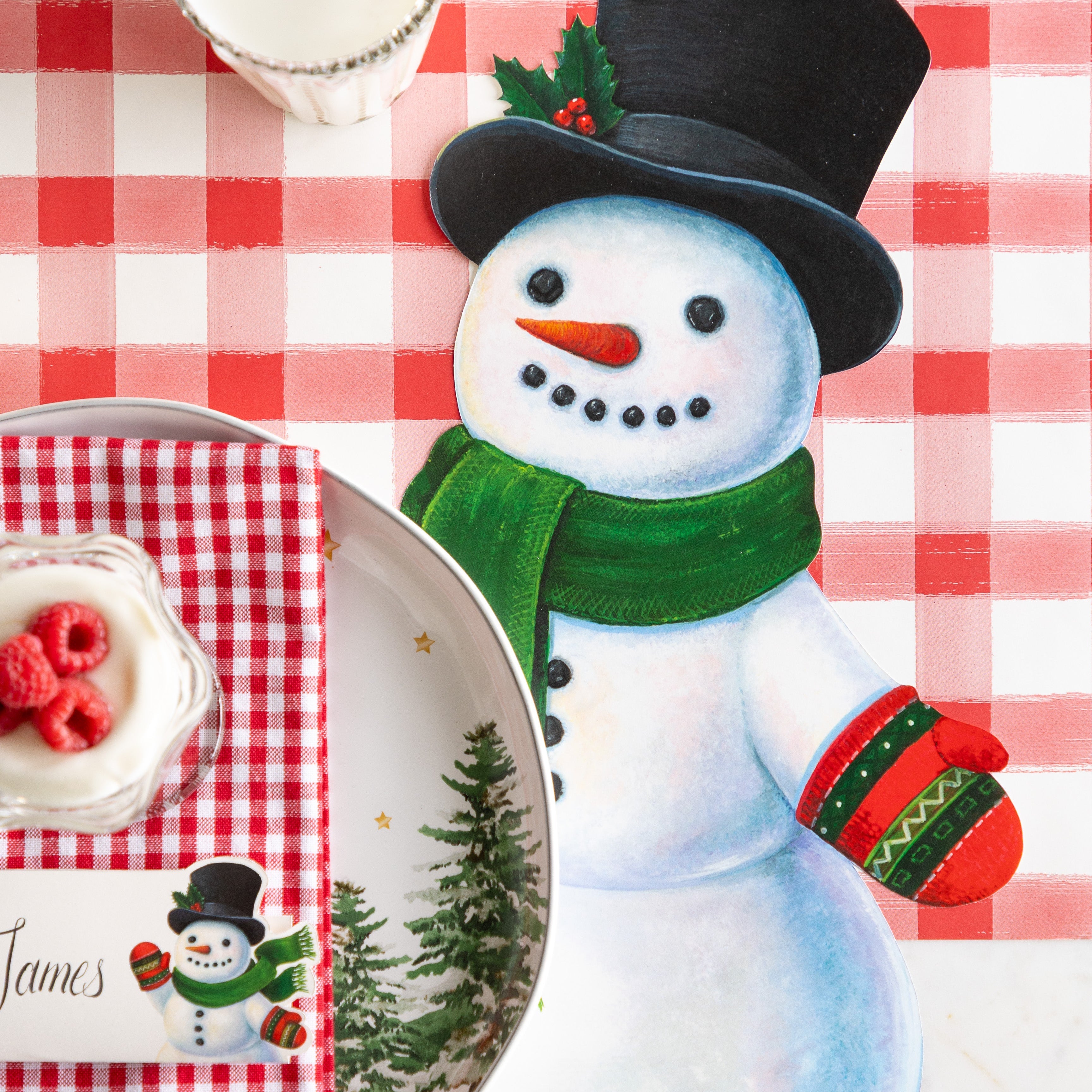 A festive table setting with the Die-cut Jolly Snowman Placemat on the Red Painted Check Runner.