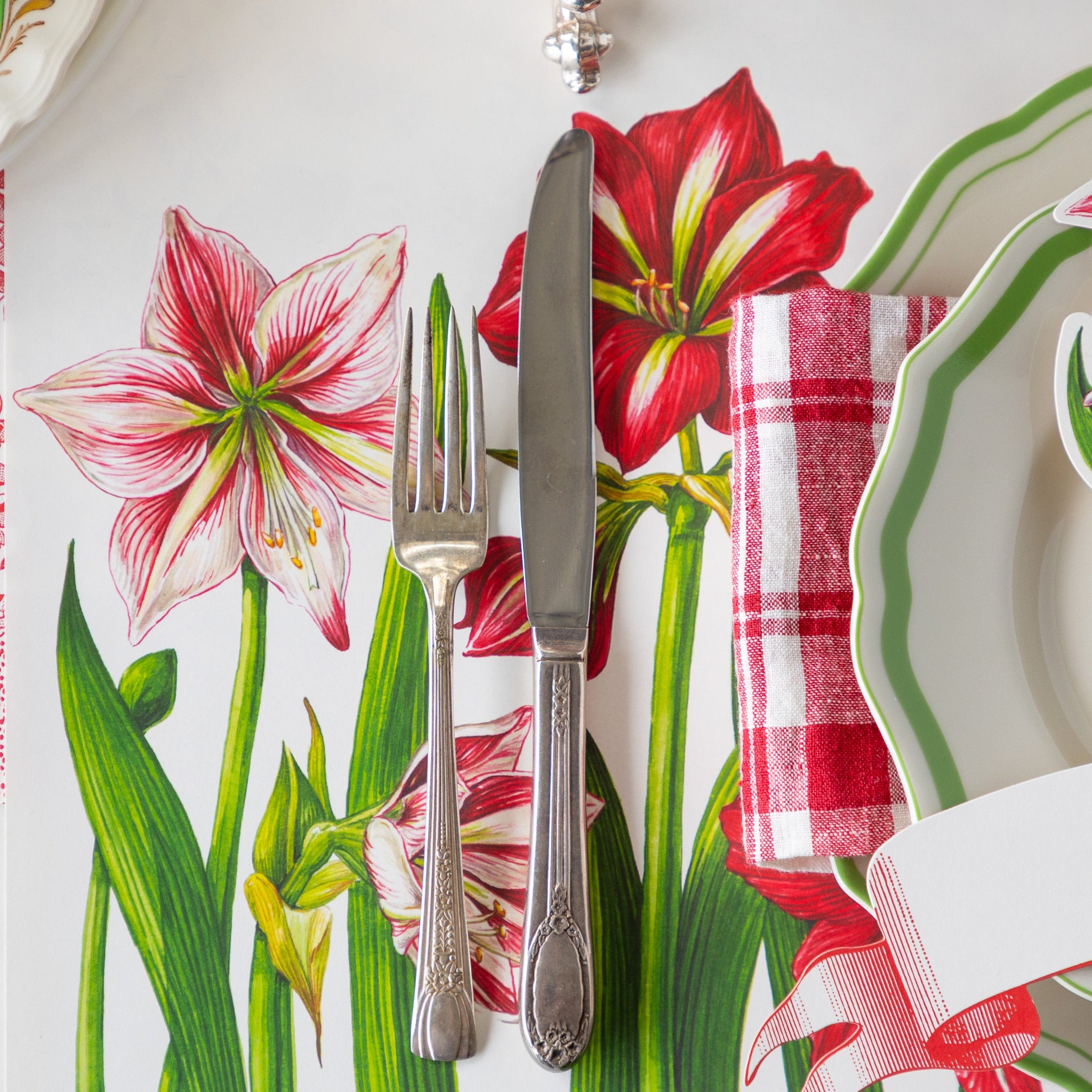 Amaryllis Placemat under vintage silverware and a place setting.