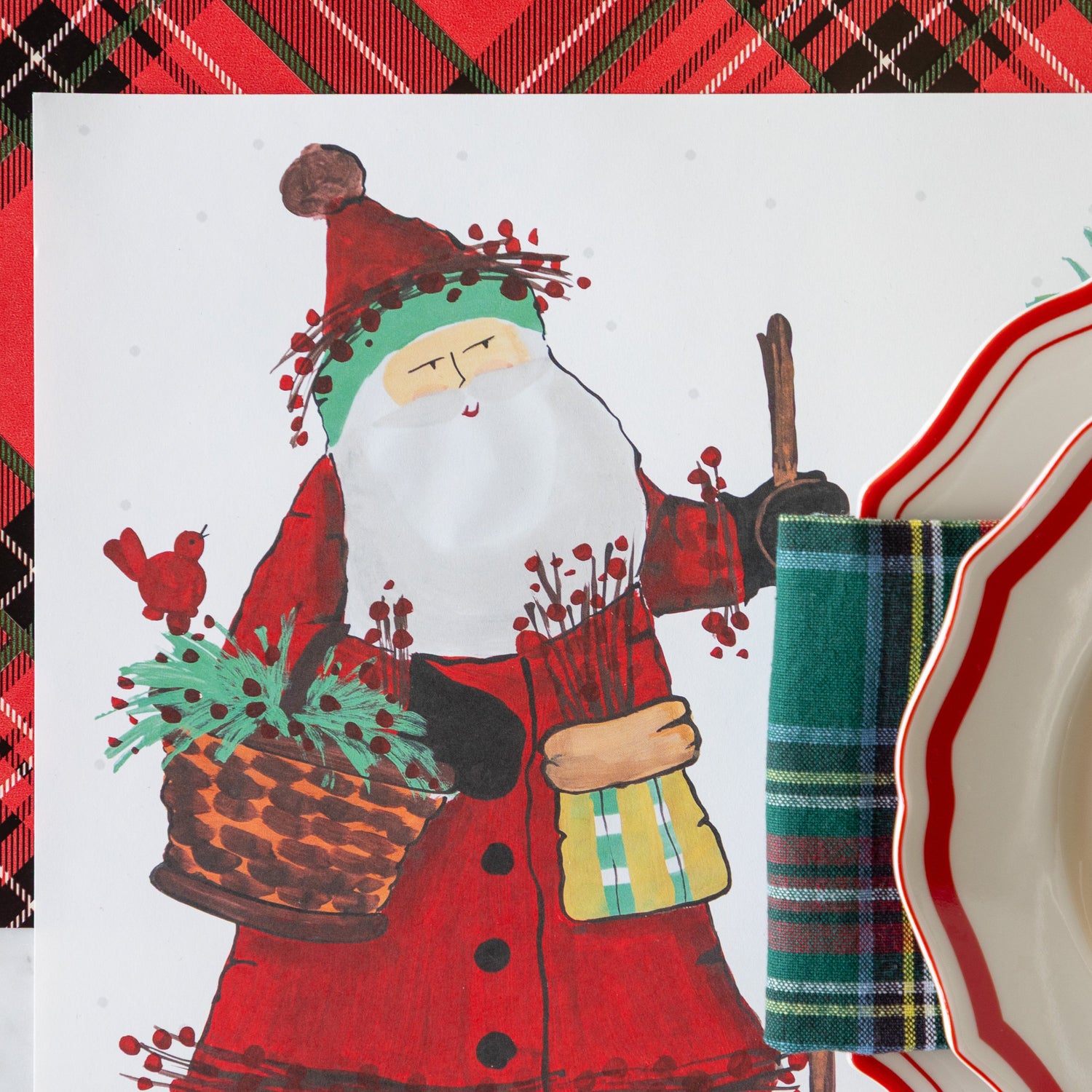 Christmas-themed table setting with Old St. Nick Forest Placemat on the Red Plaid Runner.