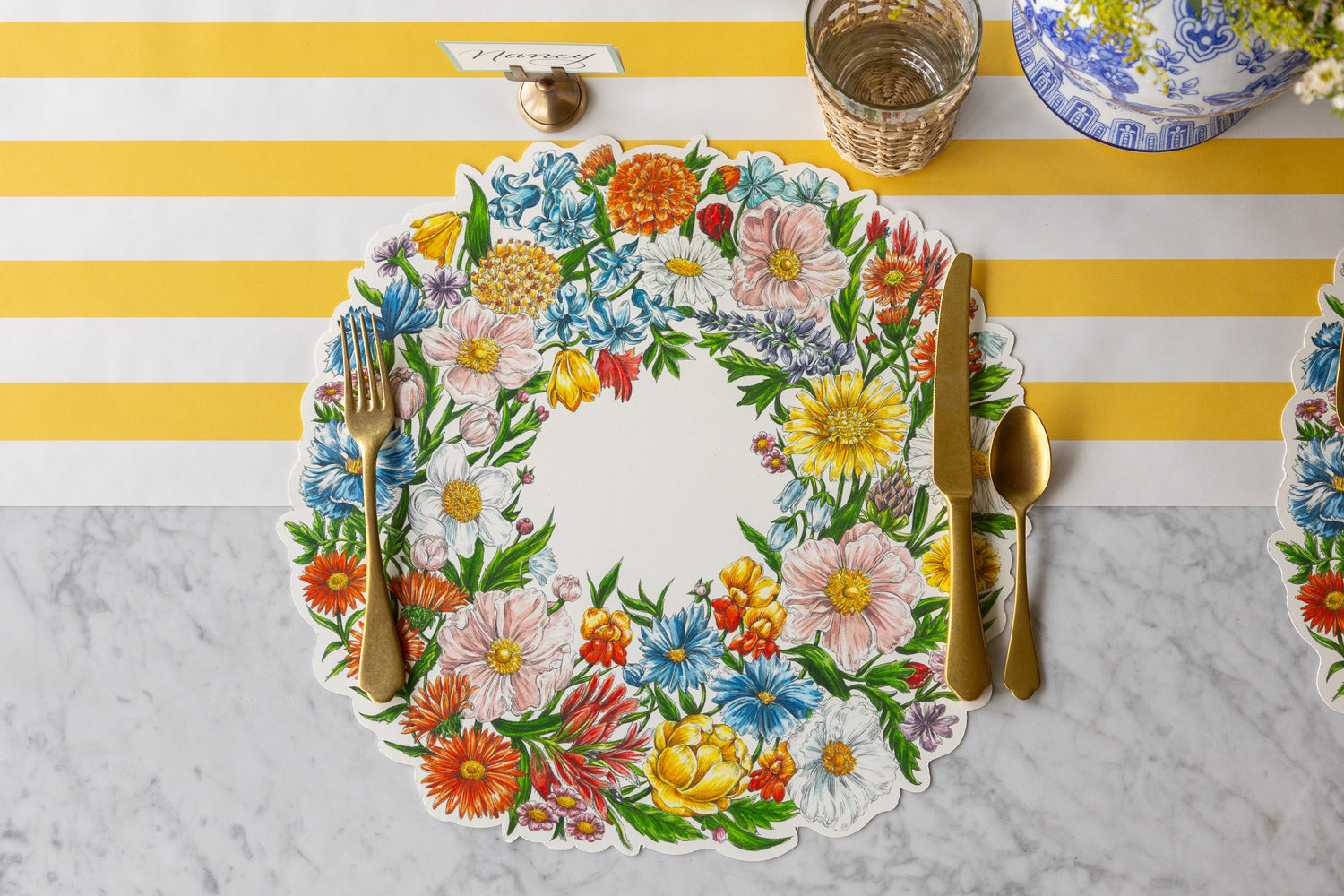 Table setting with Die-cut Wildflower  Wreath Placemat and gold cutlery on the Marigold Classic Stripe Runner.