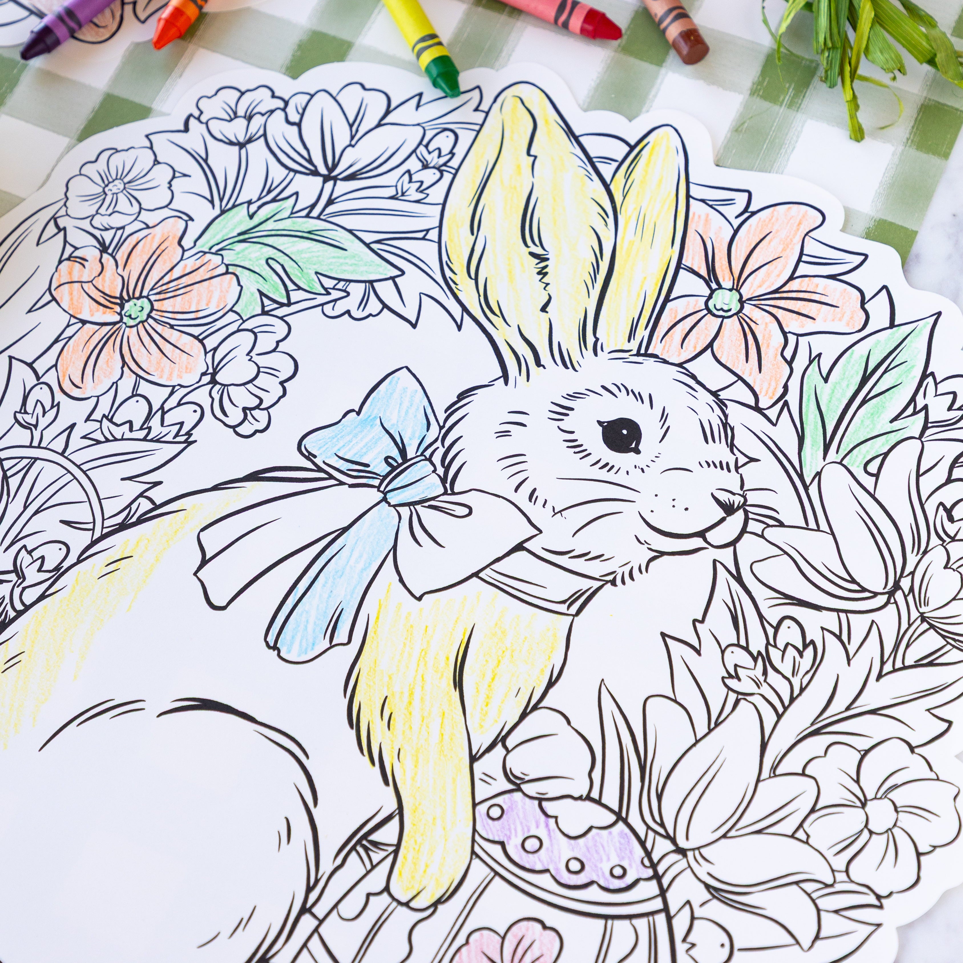 Die-cut Coloring Bunny Wreath Placemat partially colored in on the Moss Painted Check Runner.