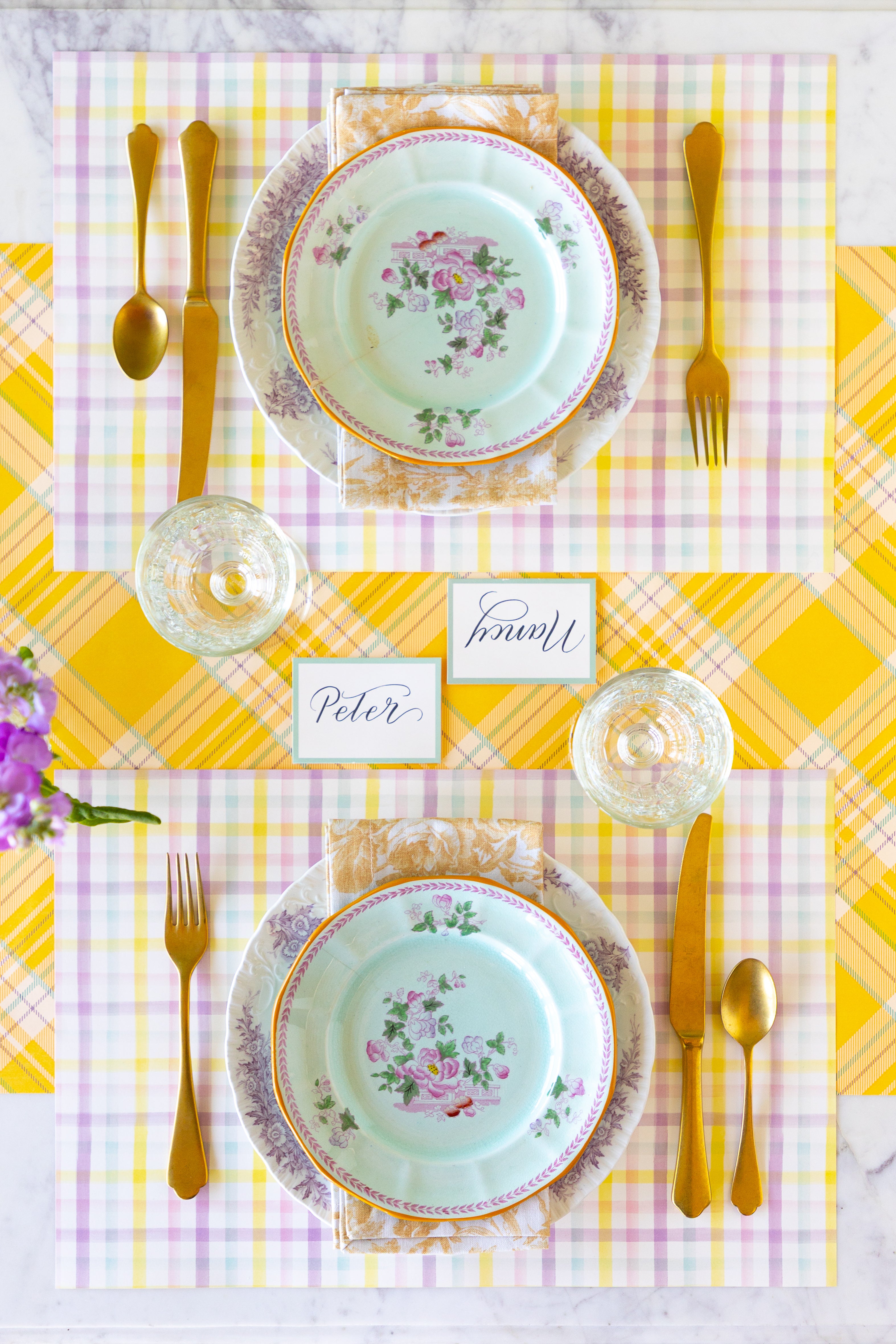 Elegant table setting with floral plates, gold cutlery, Spring Plaid Placemats and Seafoam Frame Place Cards on the Yellow Plaid Runner.