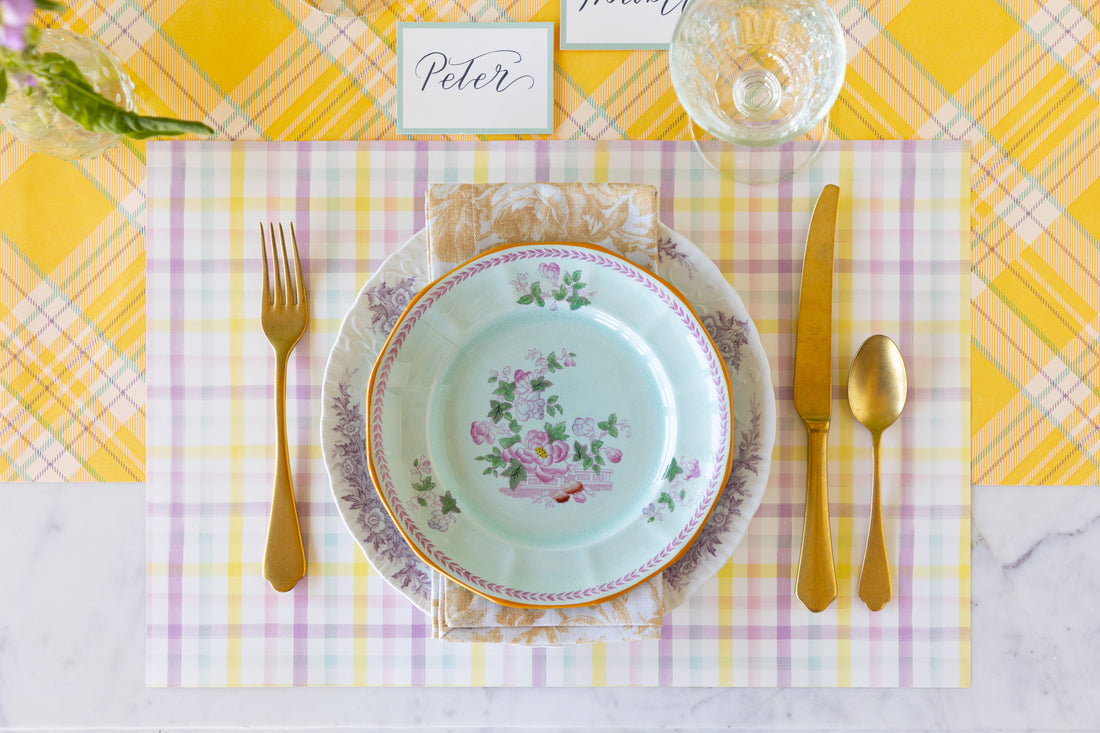 Elegant table setting with floral plates, gold cutlery, Spring Plaid Placemat and Seafoam Frame Place Card on the Yellow Plaid Runner.