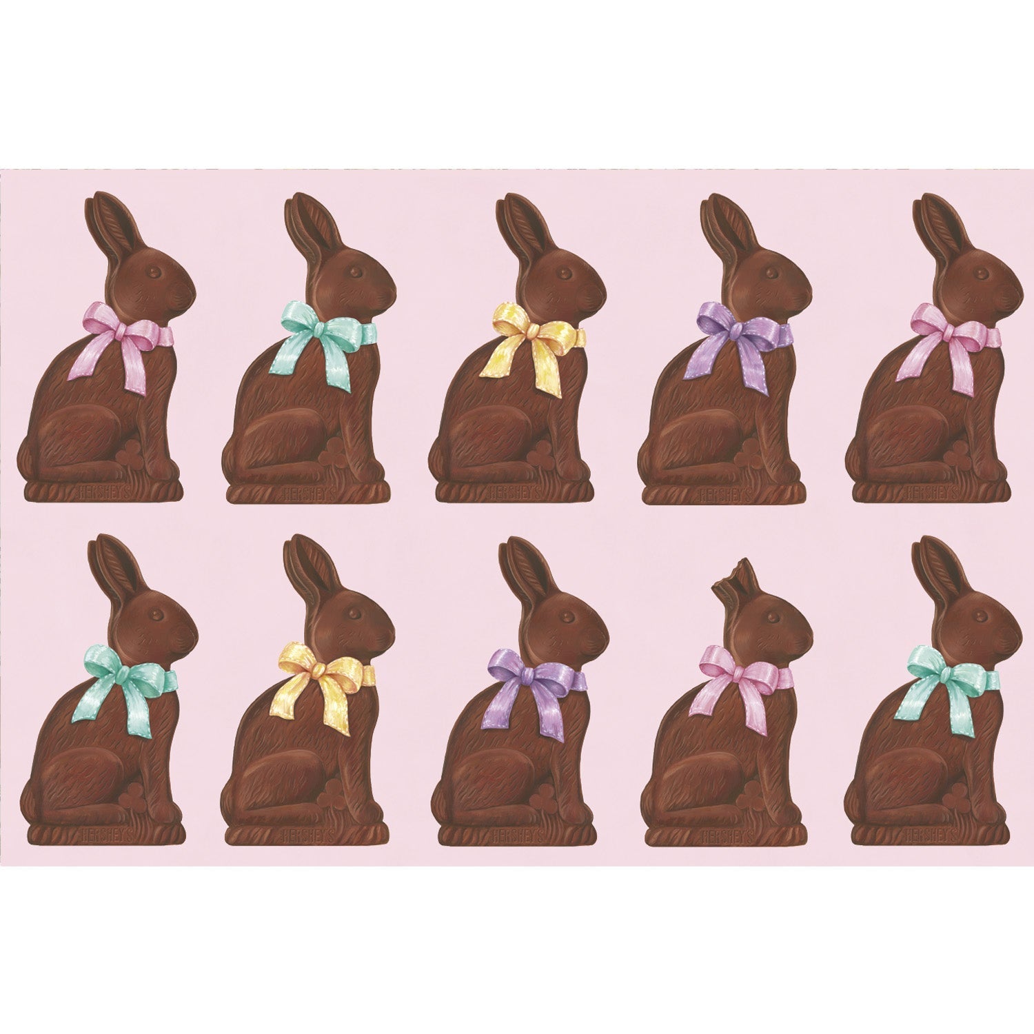 Placemat with chocolate bunnies with colorful bows on a pink background. 