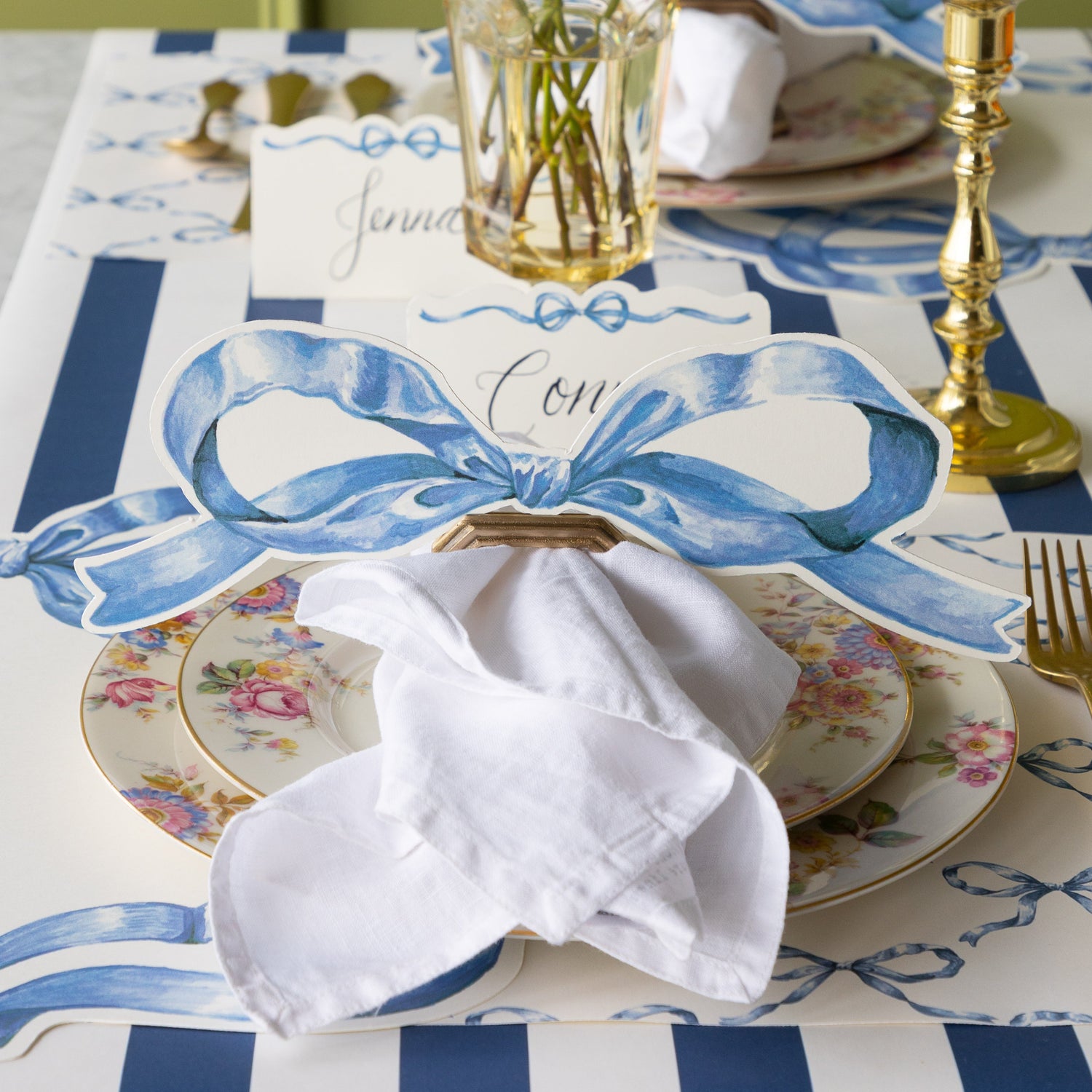 Decorative table setting with the Heirloom Blue Bow Table Accent in a place card with napkin ring holder.