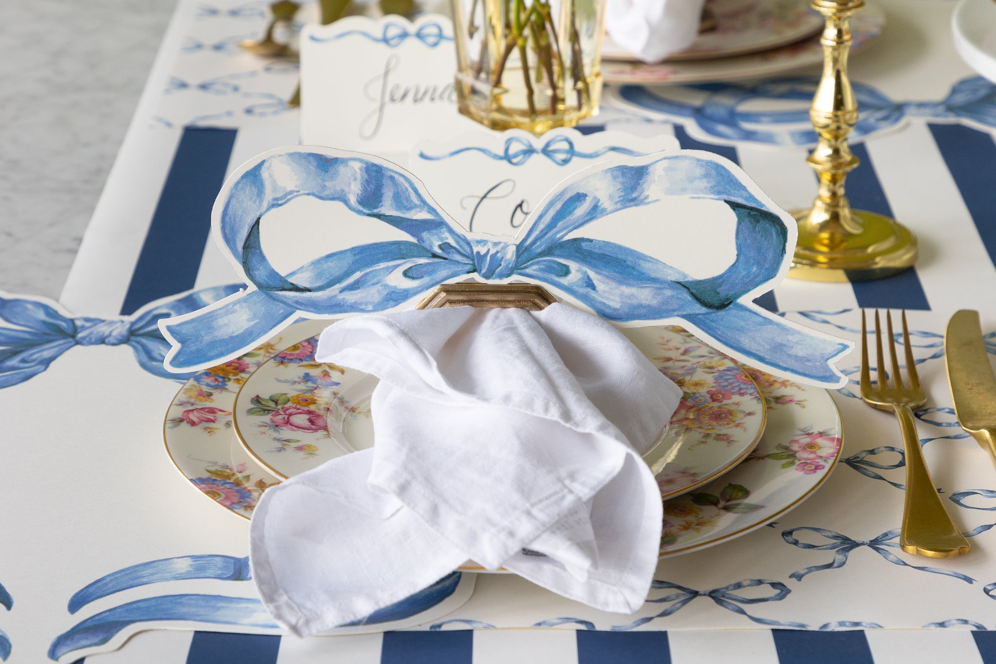 Decorative table setting with the Heirloom Blue Bow Table Accent in a place card with napkin ring holder.