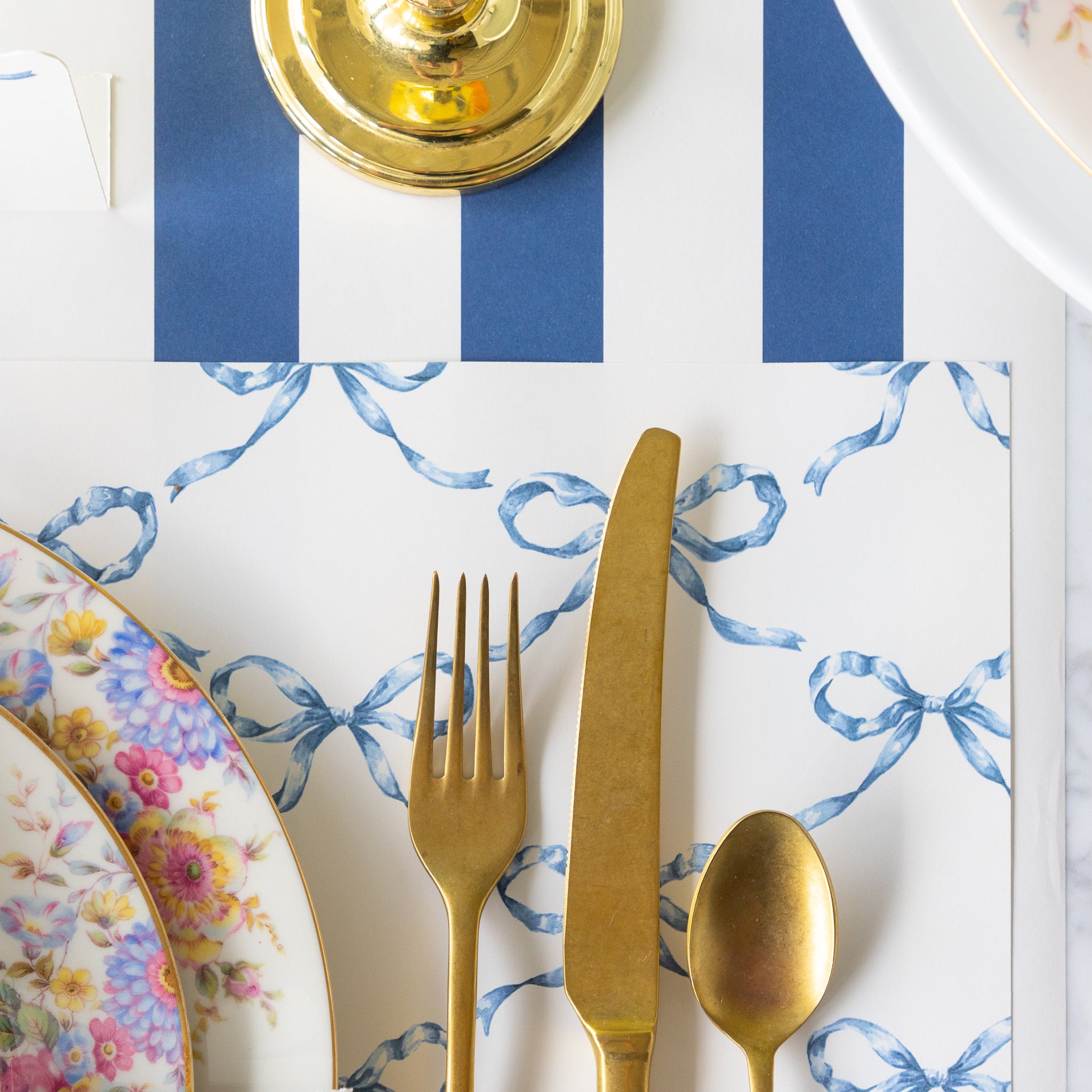 Table setting with the Heirloom Blue Bow Lattice Placemat under plates and cutlery with the Navy Classic Stripe Runner underneath.