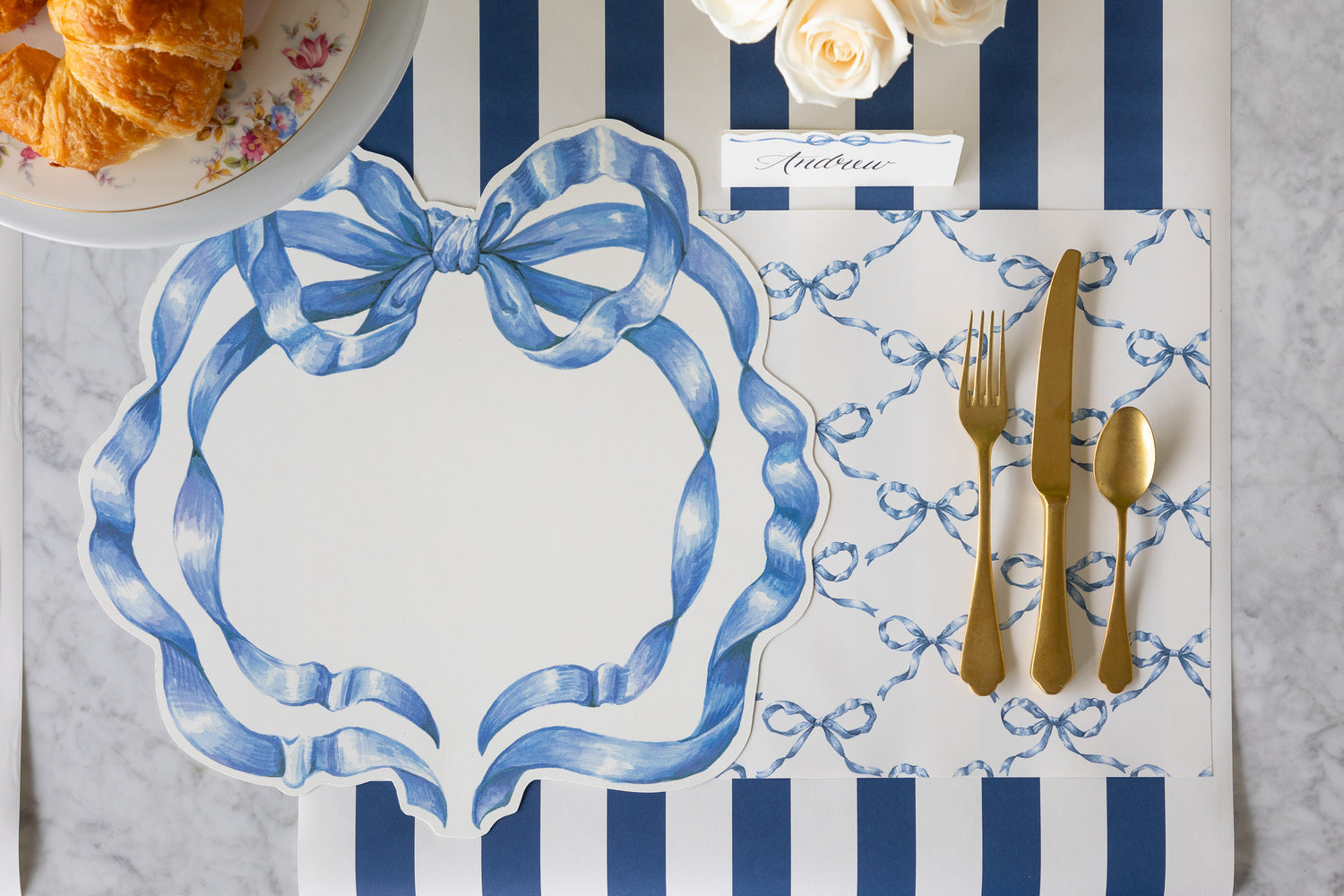 Table setting with the Die-cut Heirloom Blue Bow and Heirloom Blue Bow Lattice Placemat, golf flatware and Heirloom Blue Bow Place Card on the Navy Classic Stripe Runner.