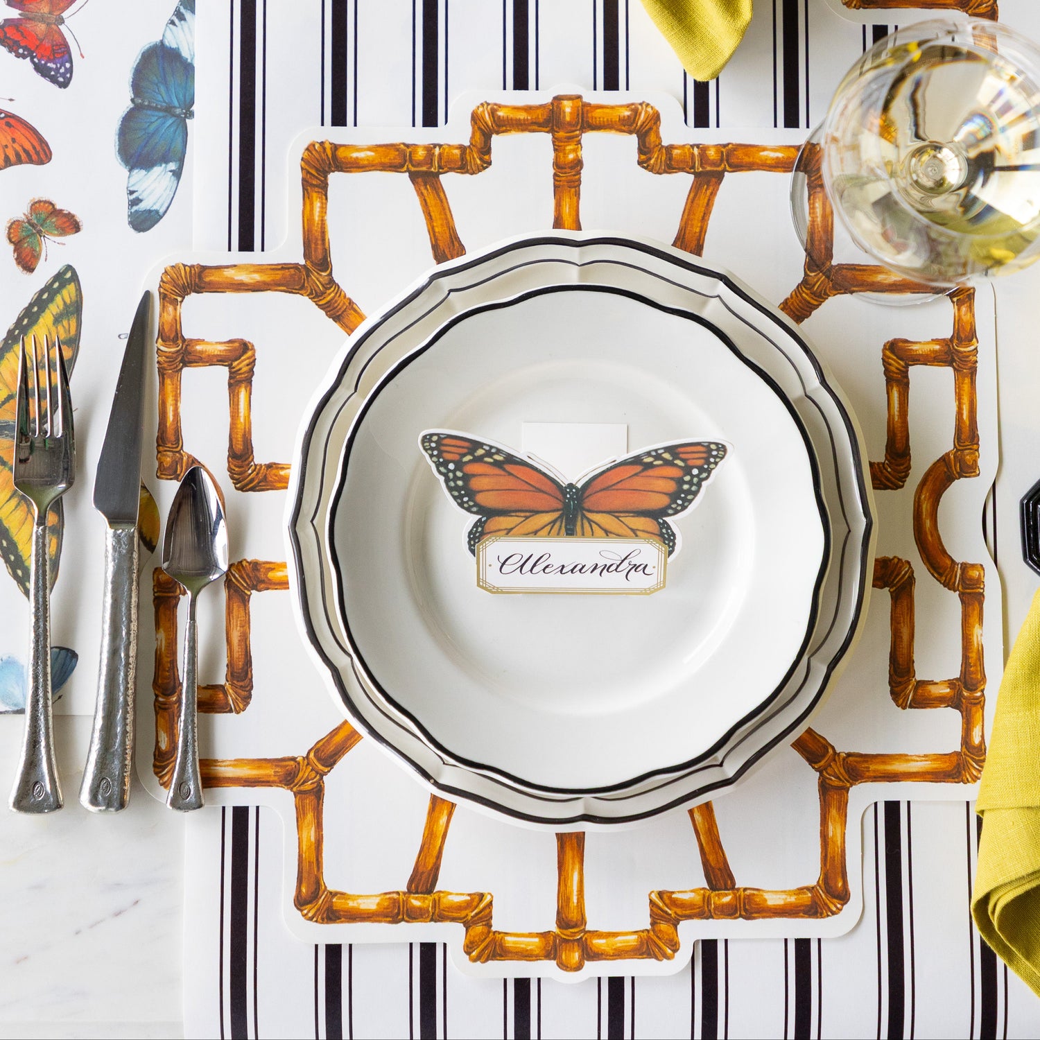 Table set with the Die-cut Bamboo Placemat, Black Icing on the Cake plates, Butterfly Place Card and vintage flatware on the Black Linen and Butterflies Runners.
