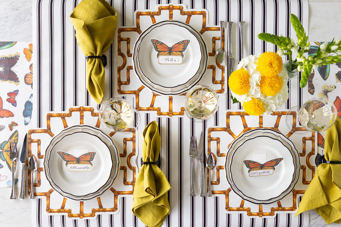 Table set with the Die-cut Bamboo Placemats, Black Icing on the Cake plates, Butterfly Place Cards and vintage flatware on the Black Linen and Butterflies Runners.