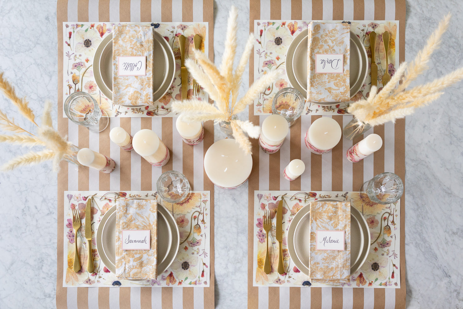 Set table with Blush Pressed Petals Placemats, cutlery, and candles on the Kraft White Classic Stripe Runner.