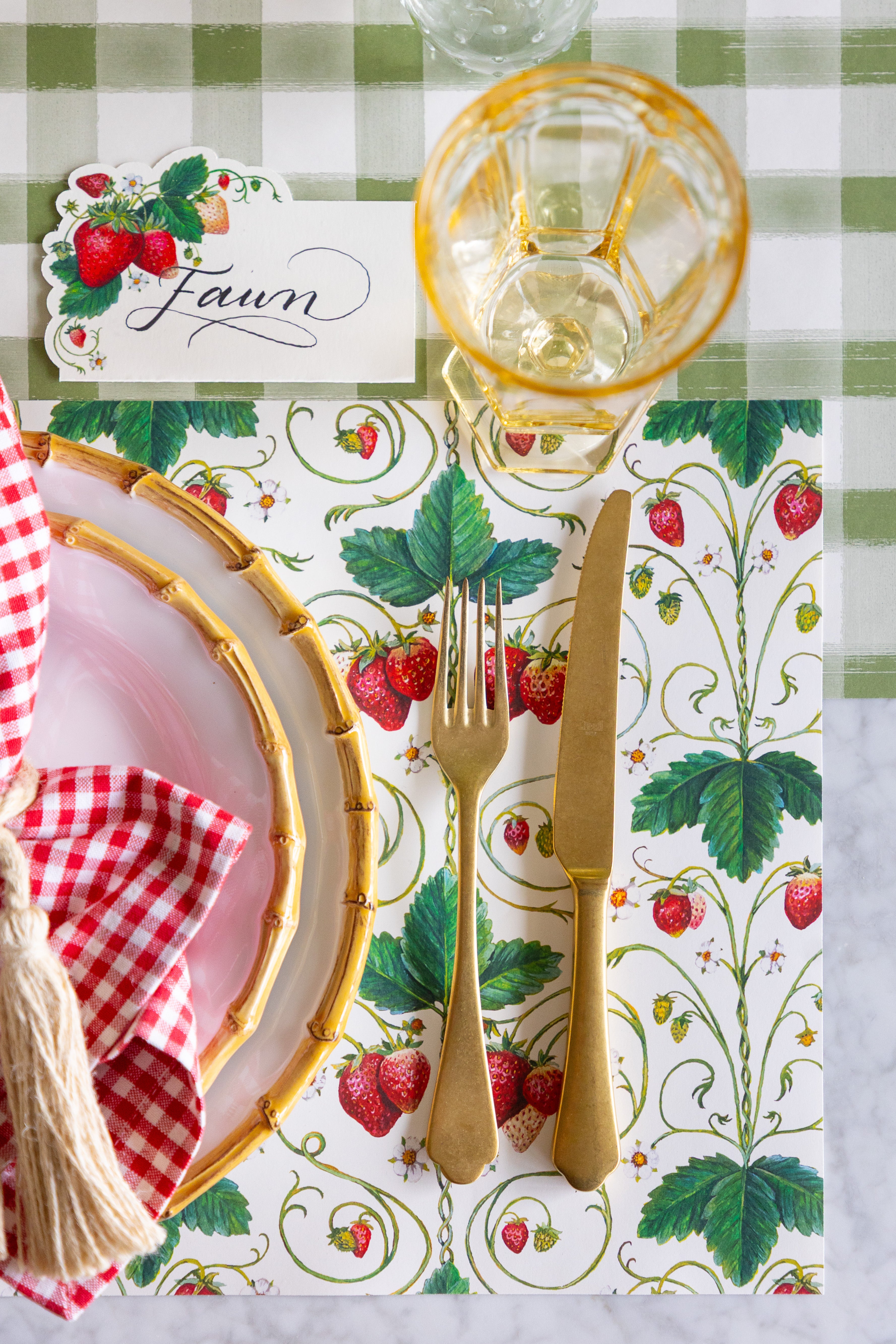 A place setting with the Strawberry Fields Placemat and Strawberries Place Card on the Moss Painted Check Runner.