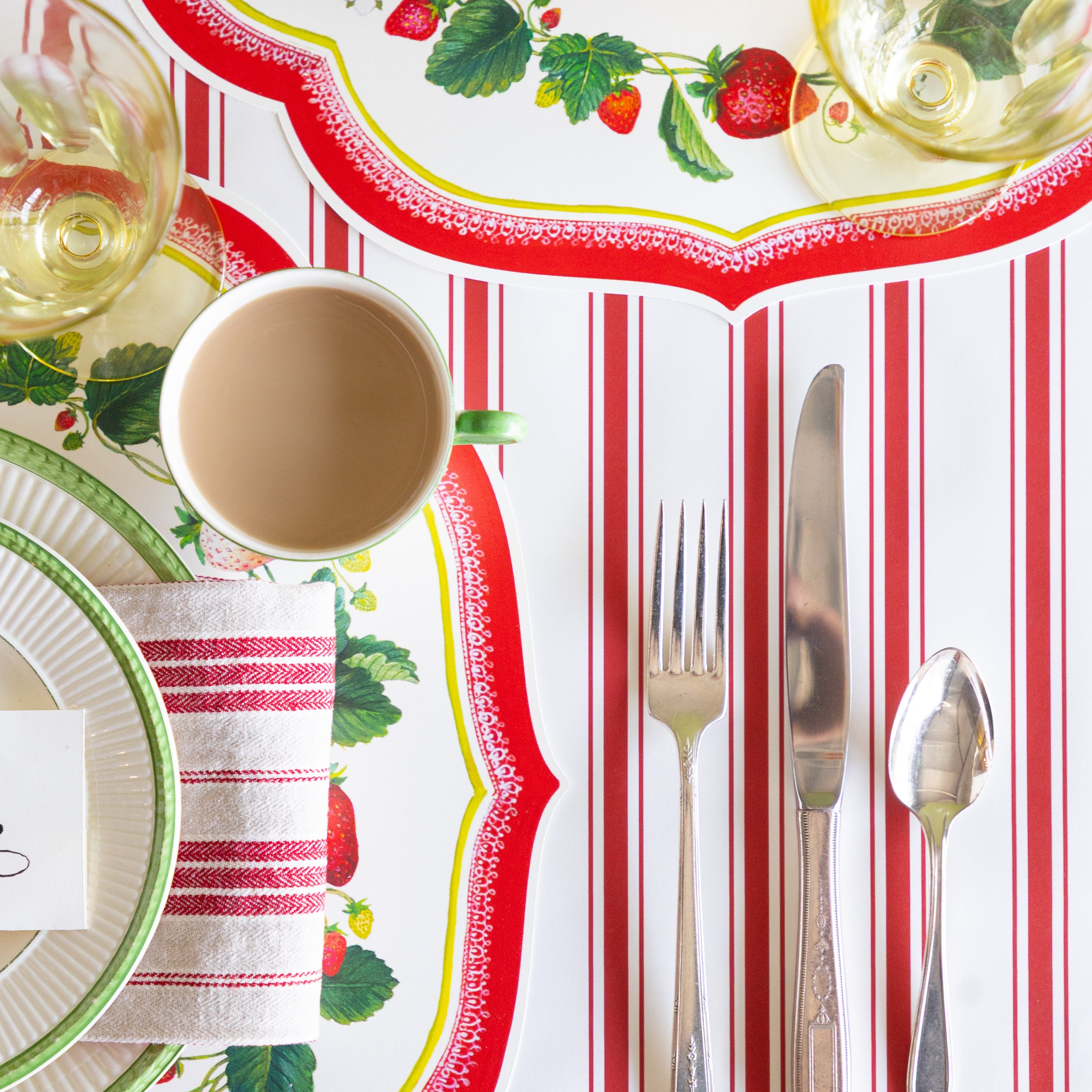 Table setting with the Die-cut Strawberry China Placemats on the Red Linen Stripe Runner.