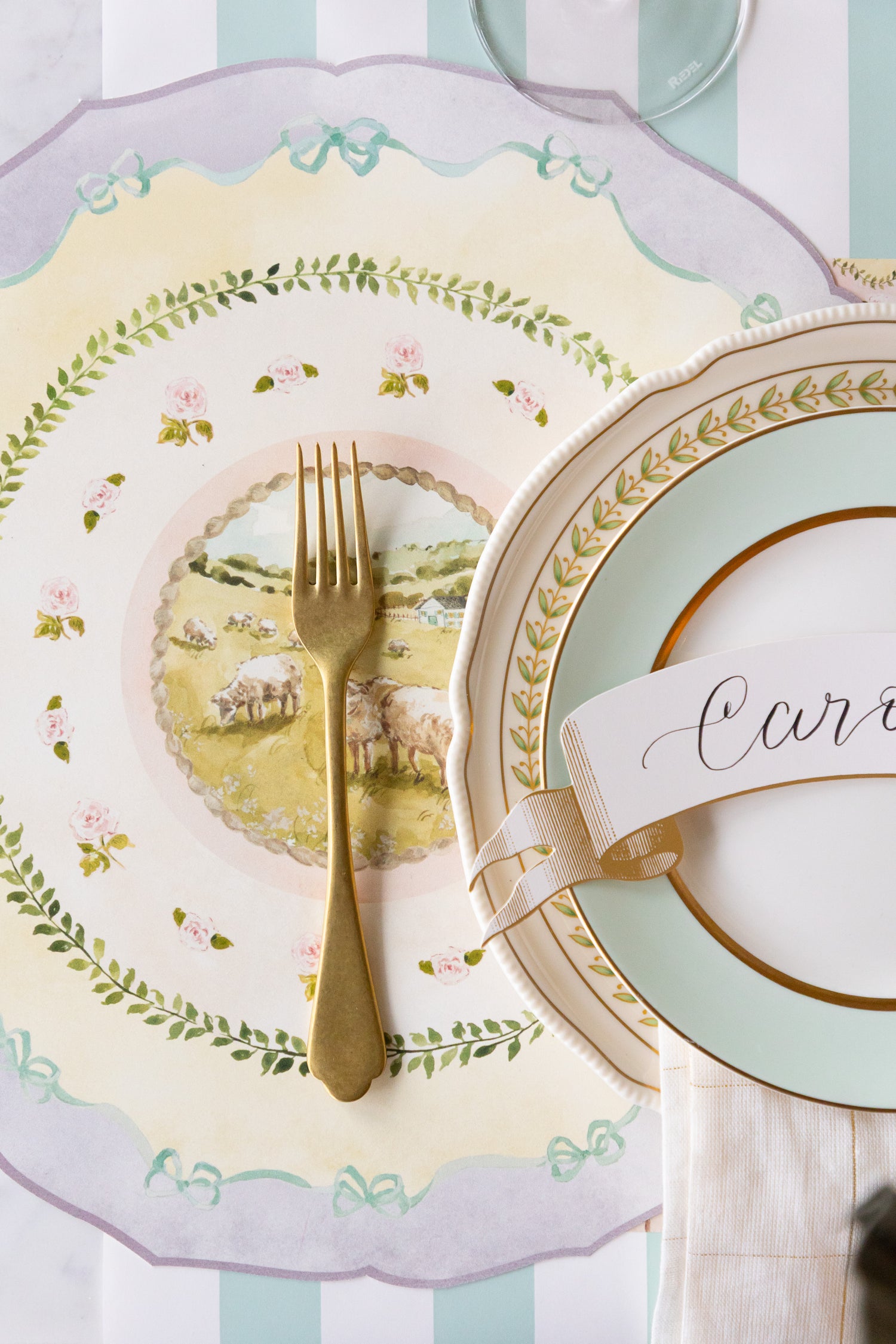Elegant table setting with decorative plates, glasses, cutlery and Die-cut spring Meadow Placemat on the Seafoam Classic Stripe Runner.