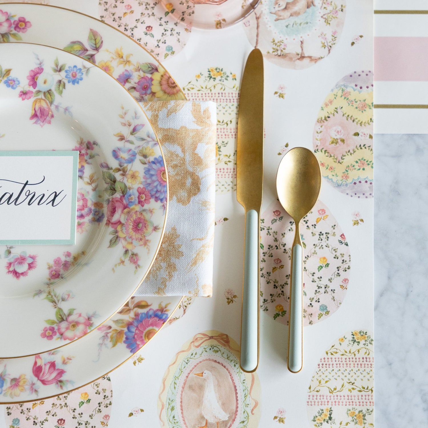 Table setting with floral plates, Fantasia Sage cutlery and Sweet Spring Eggs Placemat.