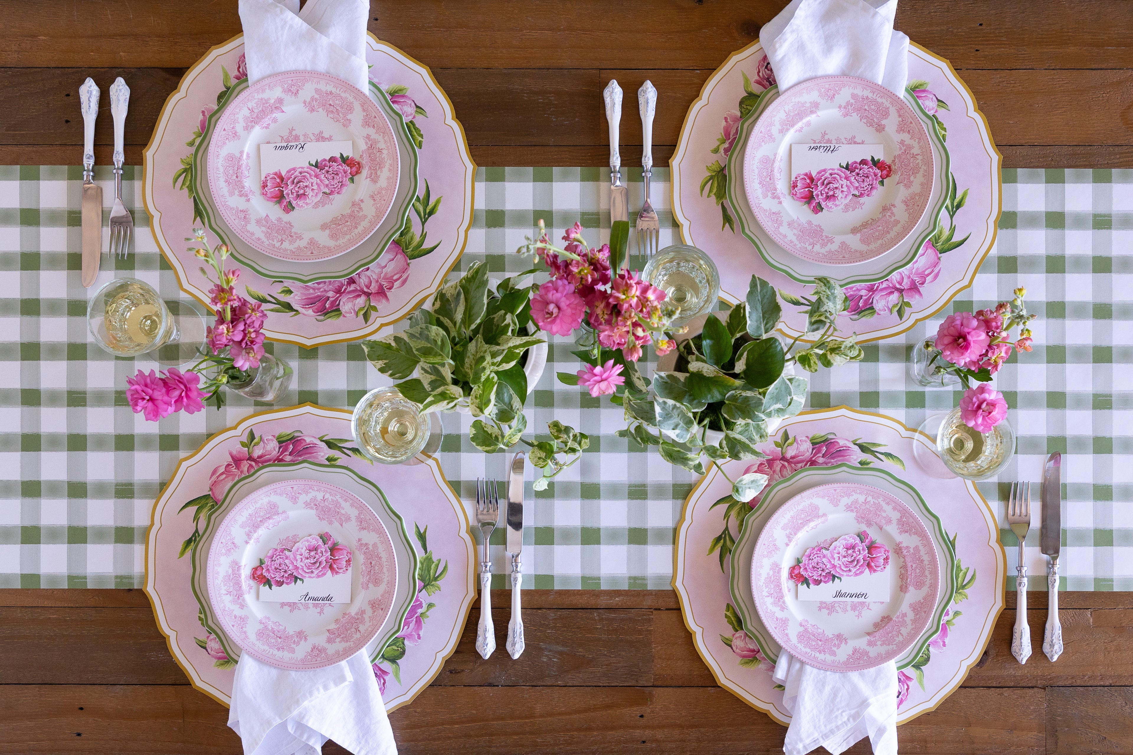 Decorative place setting with Die-cut Peony China Placemats, green rimmed and pink floral plates, vintage cutlery and flowers on the Moss Painted Check Runner.