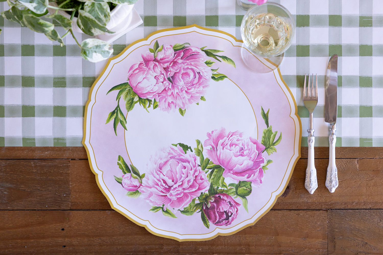 Die-cut Peony China Placemat, vintage cutlery and glass of wine on the Moss Painted Check Runner.