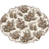 A decorative placemat with toile pattern of Autumnal scenes. 