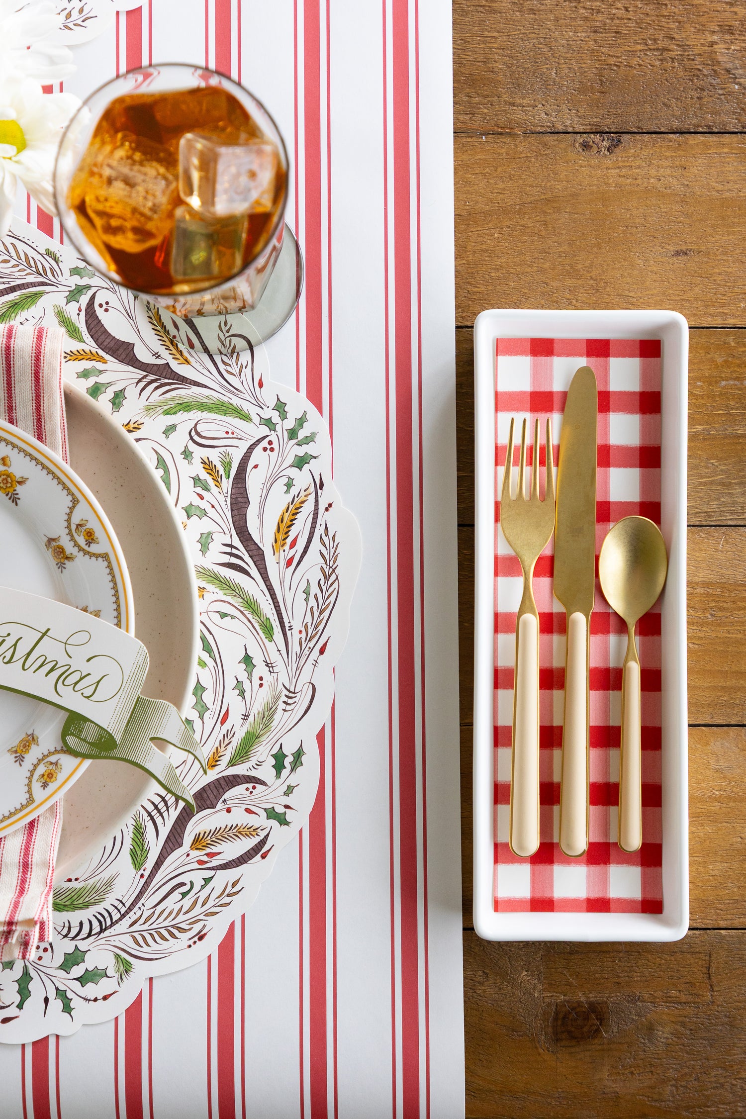 Table setting with cutlery,  glass with a drink, and decorative table setting. 