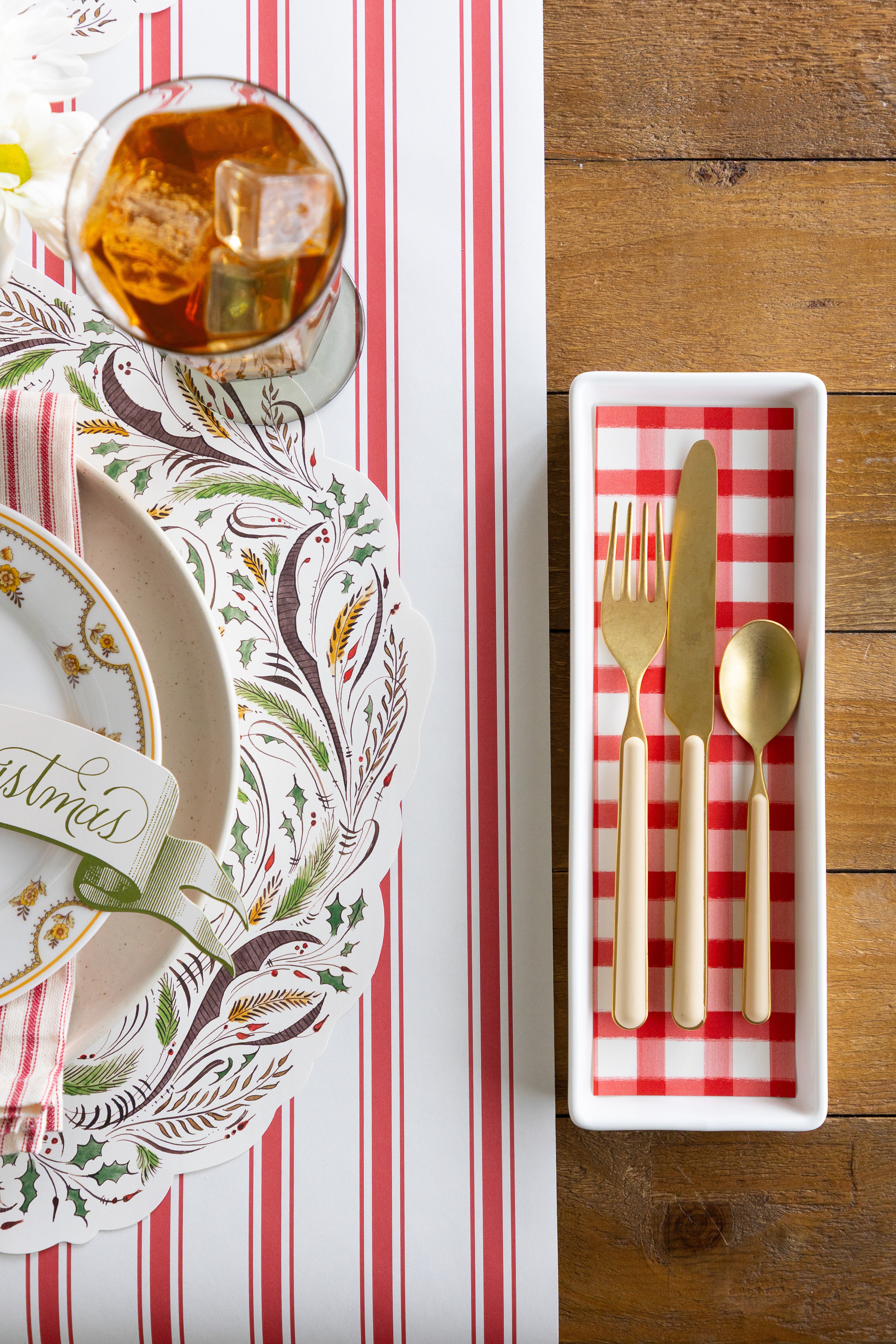 Table setting with cutlery,  glass with a drink, and decorative table setting. 