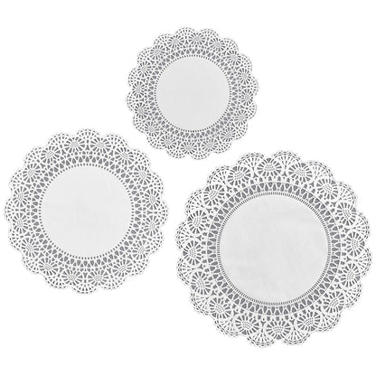 Three white, circular, die-cut doilies with solid centers and intricately decorated edges, in three different sizes.