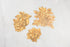 Three die-cut paper serving papers featuring illustrated gold floral embellishments for your table.