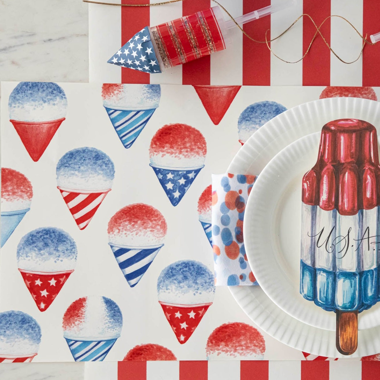 Celebrate the summer season and show your love for the USA with these festive Snow Cone placemats from Hester &amp; Cook. Perfect for adding a patriotic touch to your holiday table setting, these placemats will surely impress.