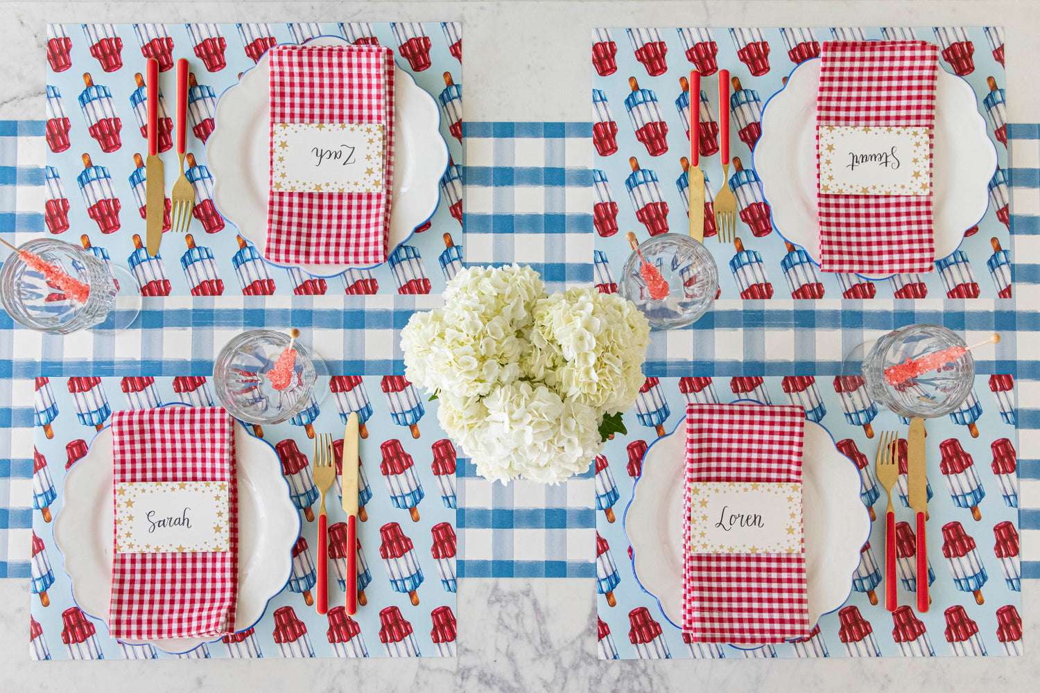 Patriotic Rocket Pop Placemats on a blue plaid paper table runner with 4th of July table inspiration.