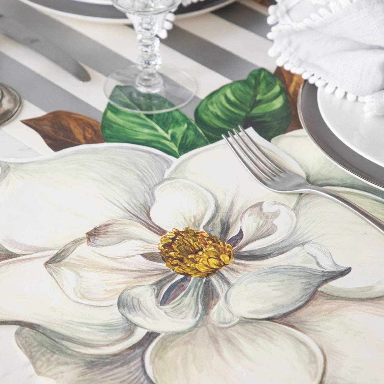 This hand drawn, in house design Hester &amp; Cook Magnolia Placemat features a beautiful Die-Cut Magnolia Placemat.