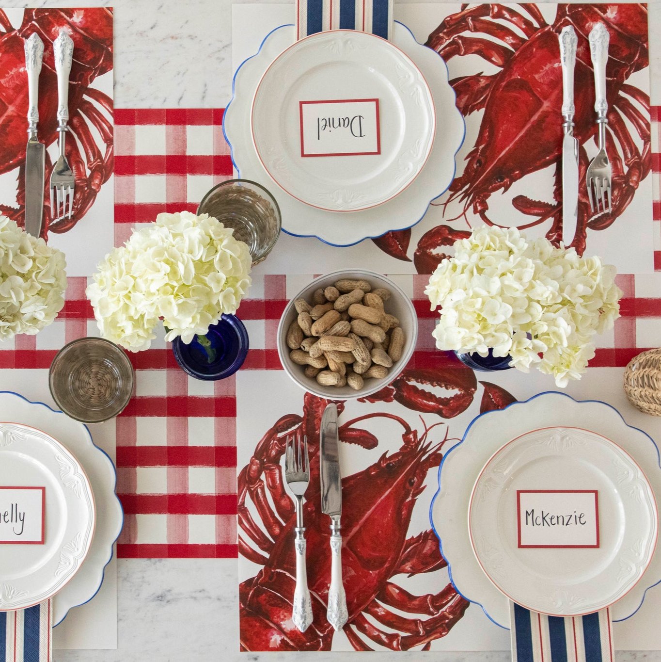 The Red Painted Check Runner on a nautical themed table setting, underneath the Lobster Placemat.