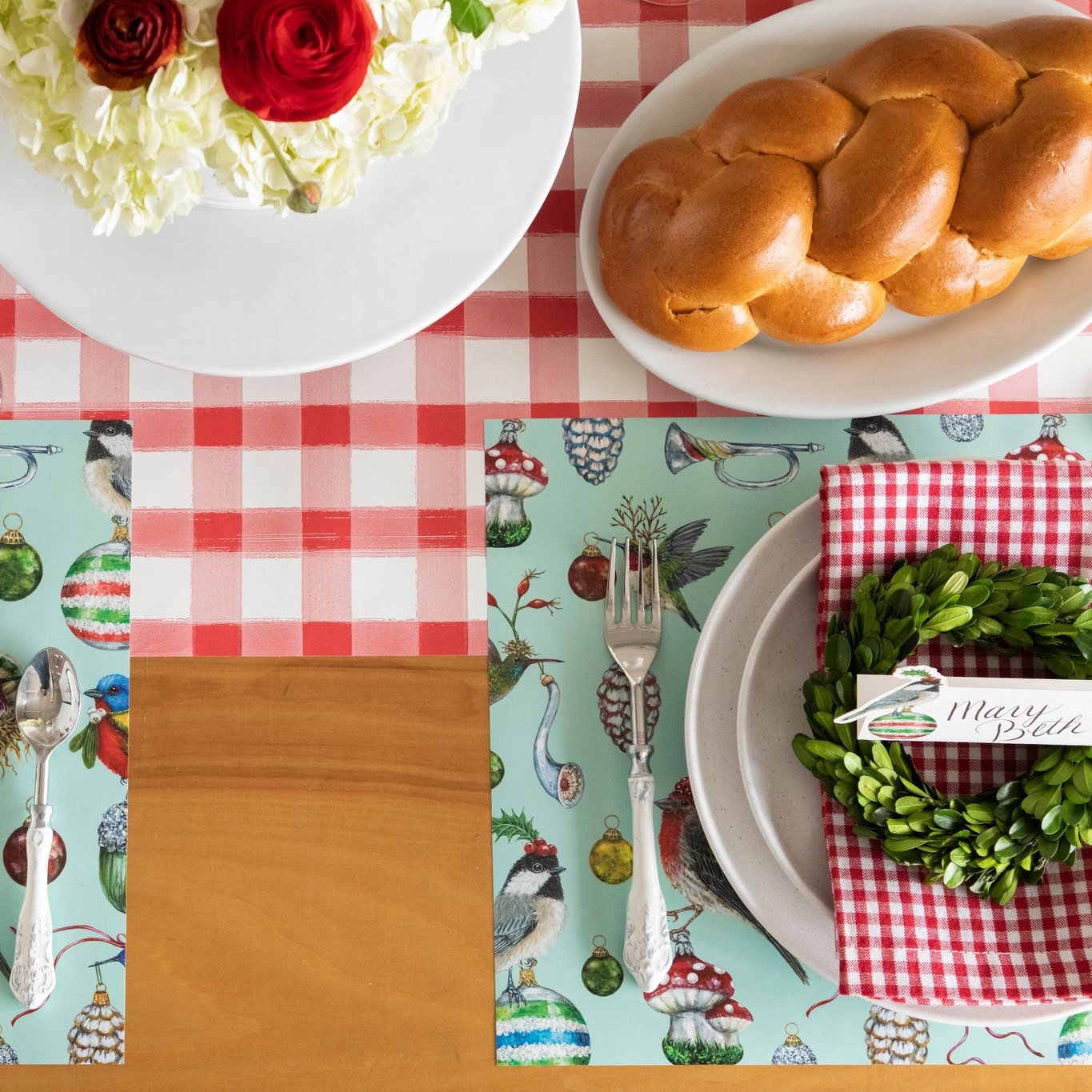 The Red Painted Check Runner on a festive table setting, underneath the Baubles and Birds Placemat.