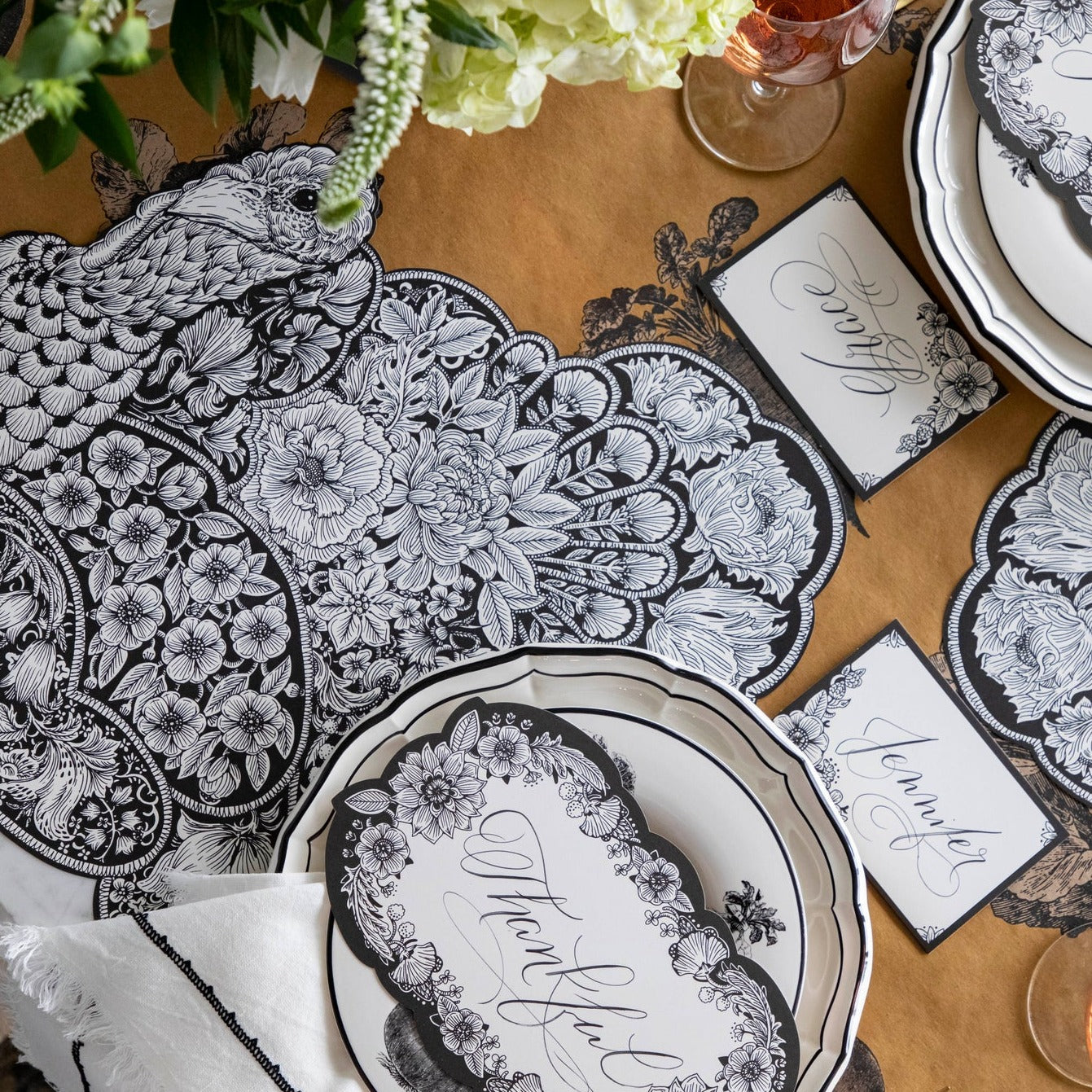 Create an autumnal Thanksgiving table with stylish black and white place settings. Enhance the festive atmosphere with the exquisite Hester &amp; Cook Die-cut Ebony Harvest Turkey Placemat.