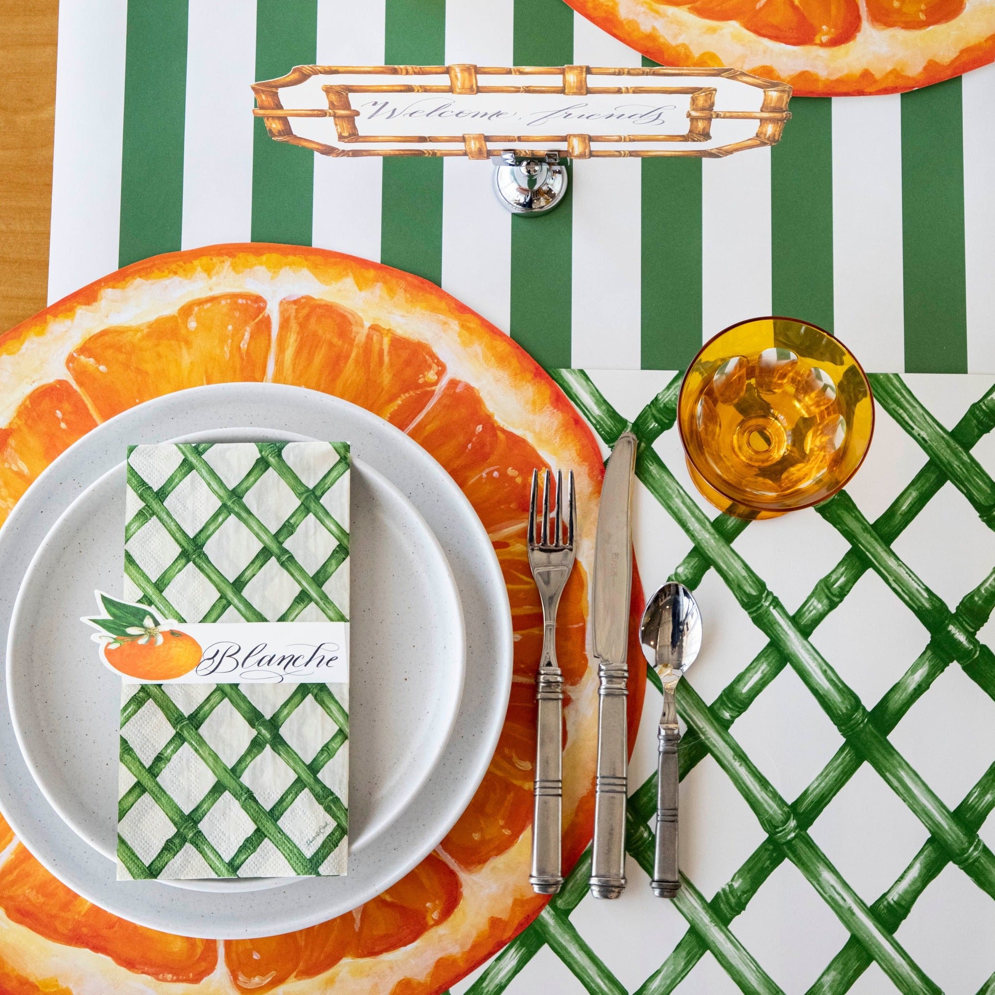The Die-cut Orange Slice Placemat under an elegant place setting from above.