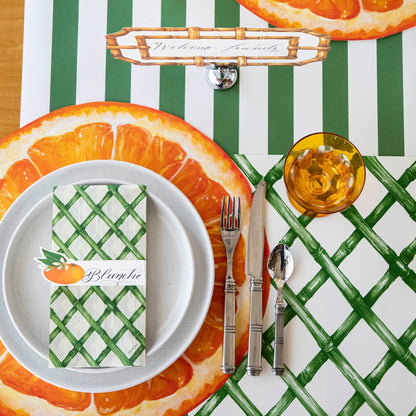 The Die-cut Orange Slice Placemat under an elegant place setting from above.