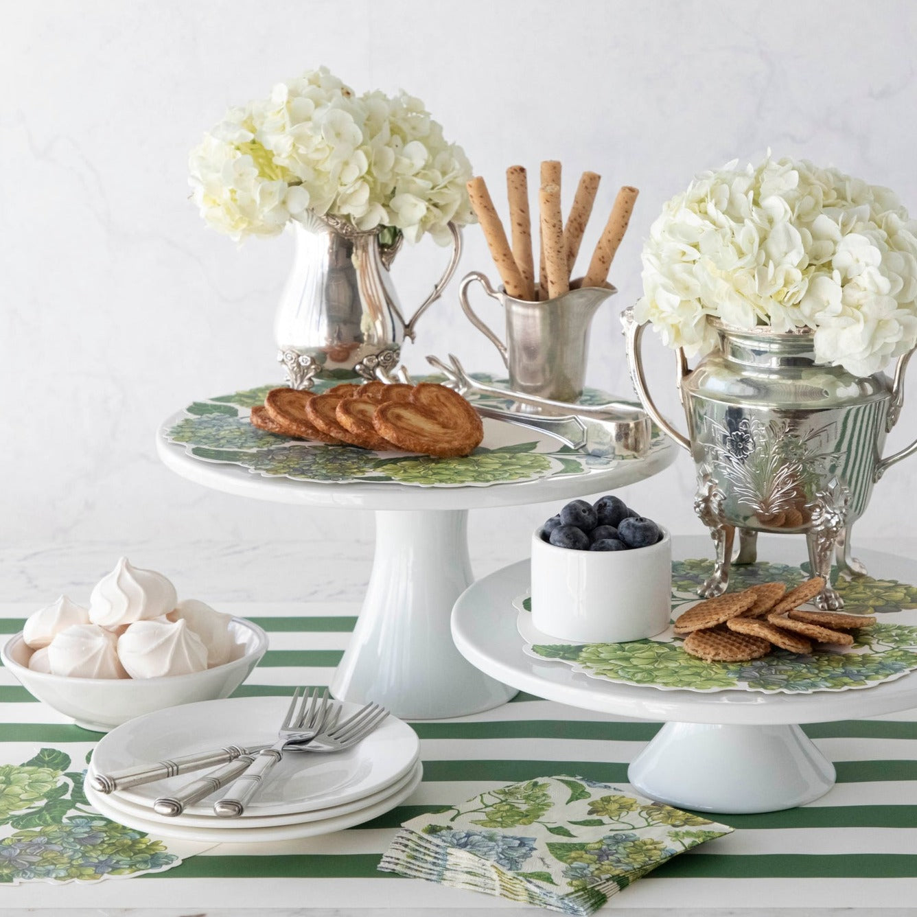 A white and green Hydrangea Serving Papers cake stand with flowers on it by Hester &amp; Cook.