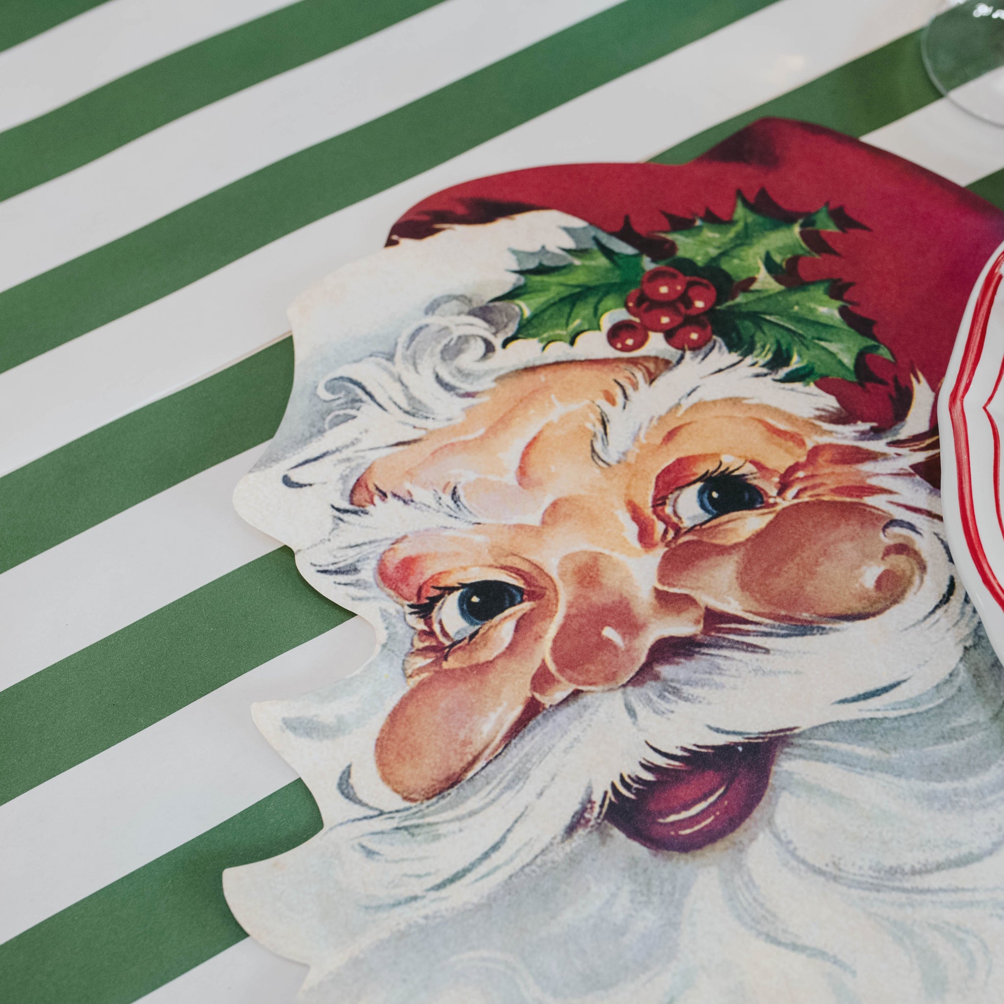 Die-cut Santa Claus Placemat on the Dark Green Classic Stripe Runner.