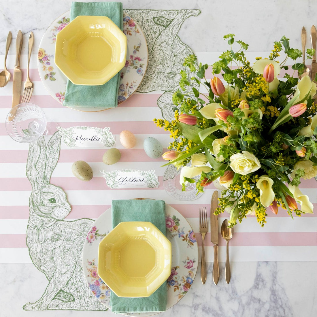 The Die-cut Greenhouse Hare Placemat under an elegant Easter table setting for two, from above.
