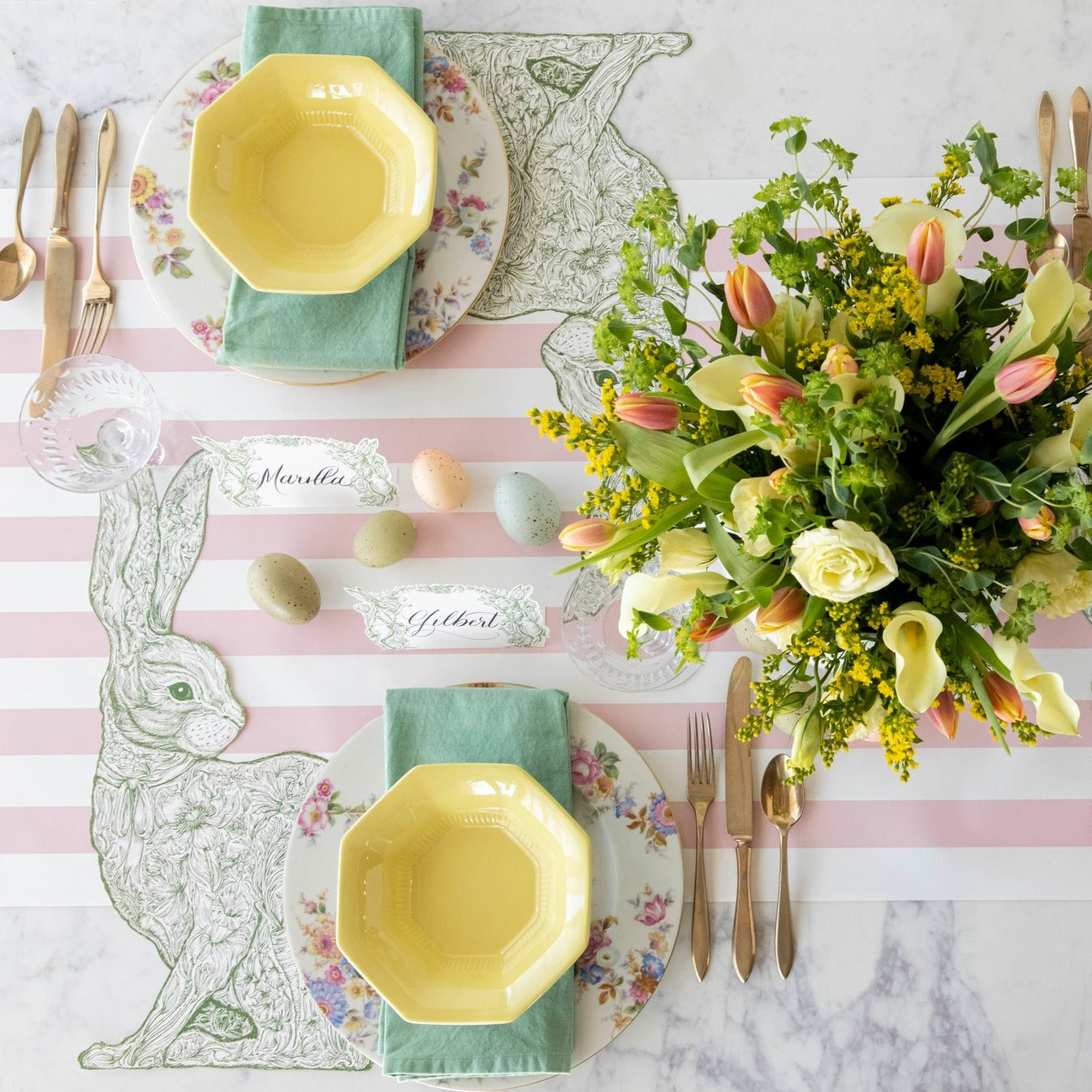 The Die-cut Greenhouse Hare Placemat under an elegant Easter table setting for two, from above.