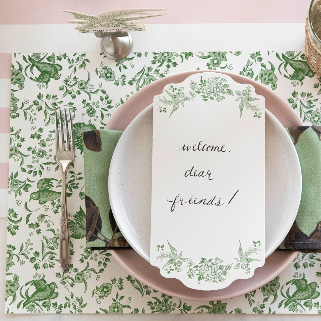 An ornamental Green Regal Peacock Placemat pattern featuring green and white colors with flowers, perfect for eco-conscious individuals as it is made from recycled content.