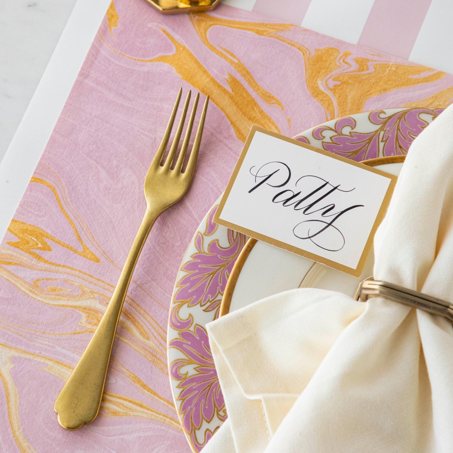Close-up of the Pink &amp; Gold Vein Marbled Placemat under an elegant place setting.