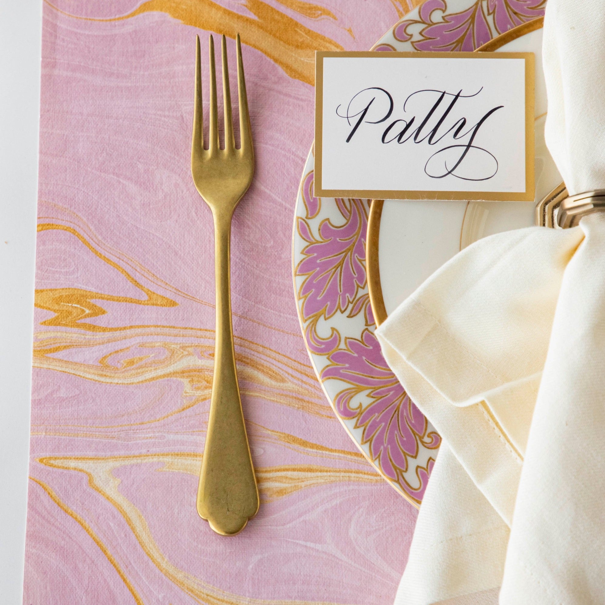 Close-up of the Pink &amp; Gold Vein Marbled Placemat under an elegant place setting, showing the gold and pink colors swirled together.
