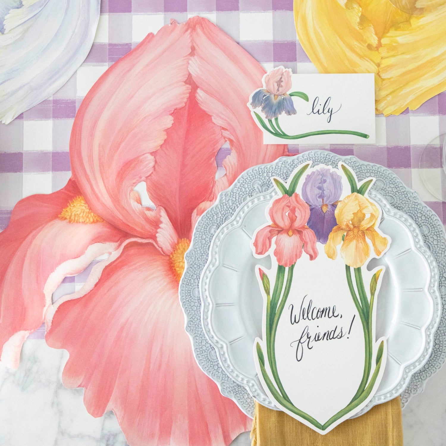 The pink Die-cut Iris Placemat under a vibrant springtime place setting, from above.