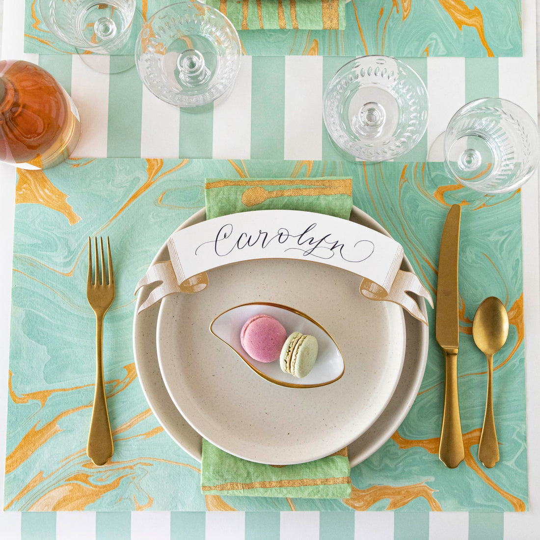 The Seafoam &amp; Gold Vein Marbled Placemat under an elegant table setting, from above.