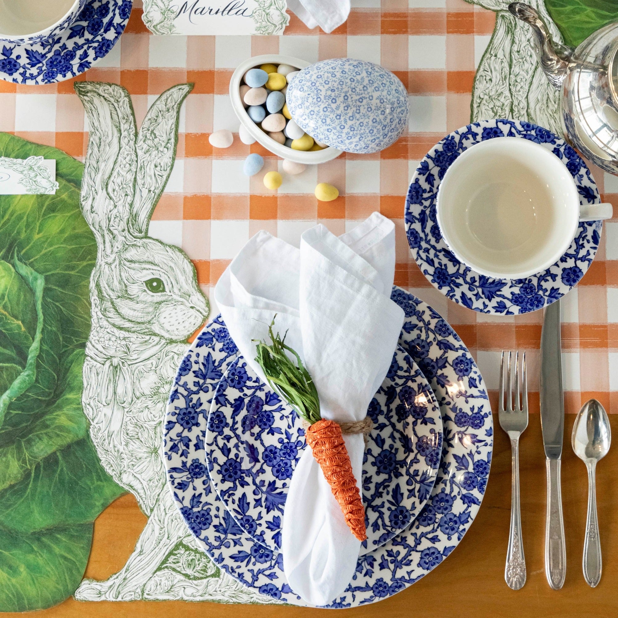 The Die-cut Greenhouse Hare Placemat under an elegant Easter place setting, from above.
