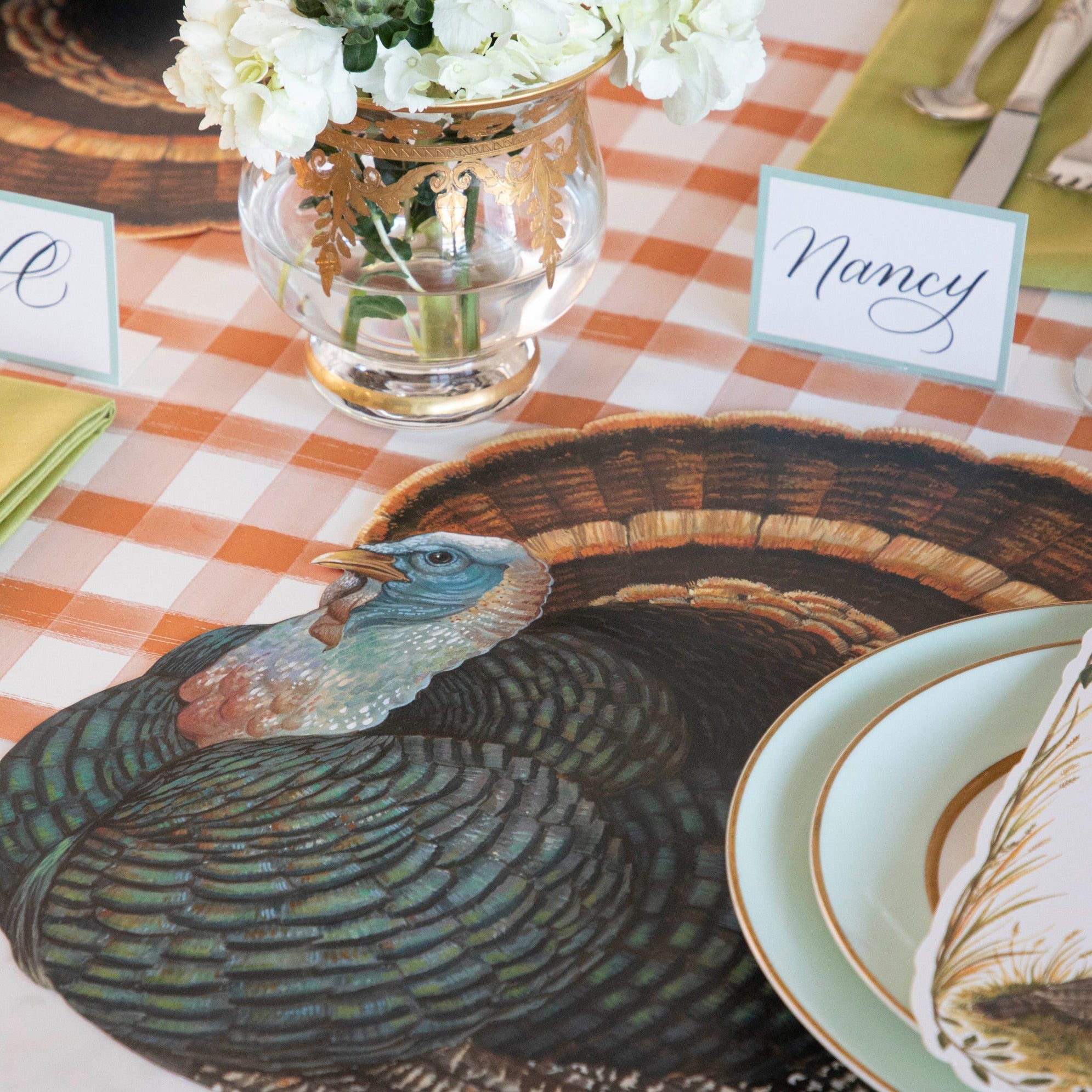 The Die-cut Heritage Turkey Placemat under an elegant Thanksgiving place setting.